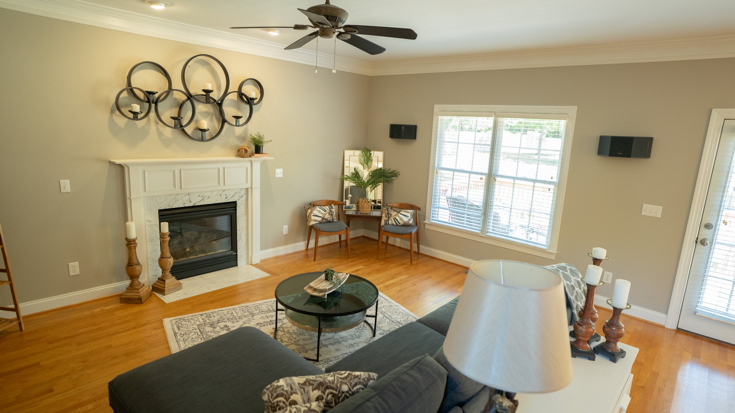 Occupied living room styled around a brick fireplace